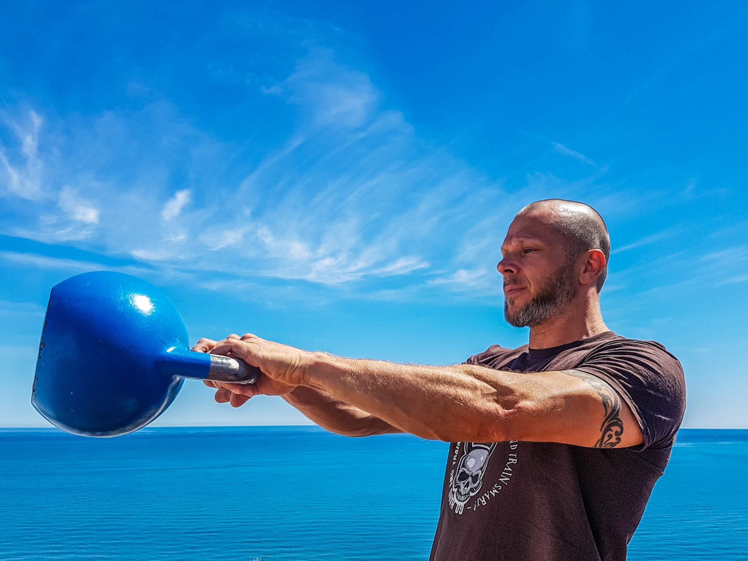 Doing a kettlebell swing - How to get more fit quickly with ultimate HIIT Fitness in Vancouver